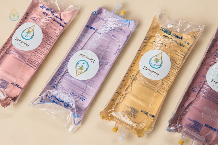 Elemental branded IV drip bags in four colors laid out on a cream surface