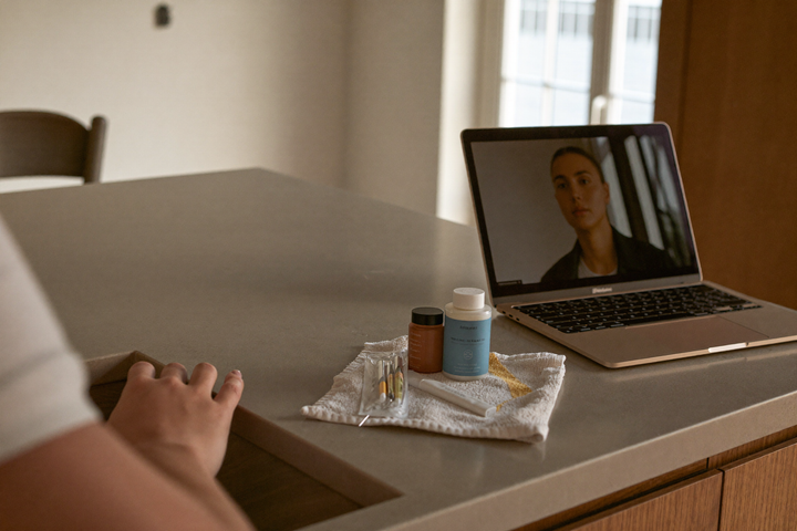 Virtual consult with a nurse on a laptop at a kitchen counter